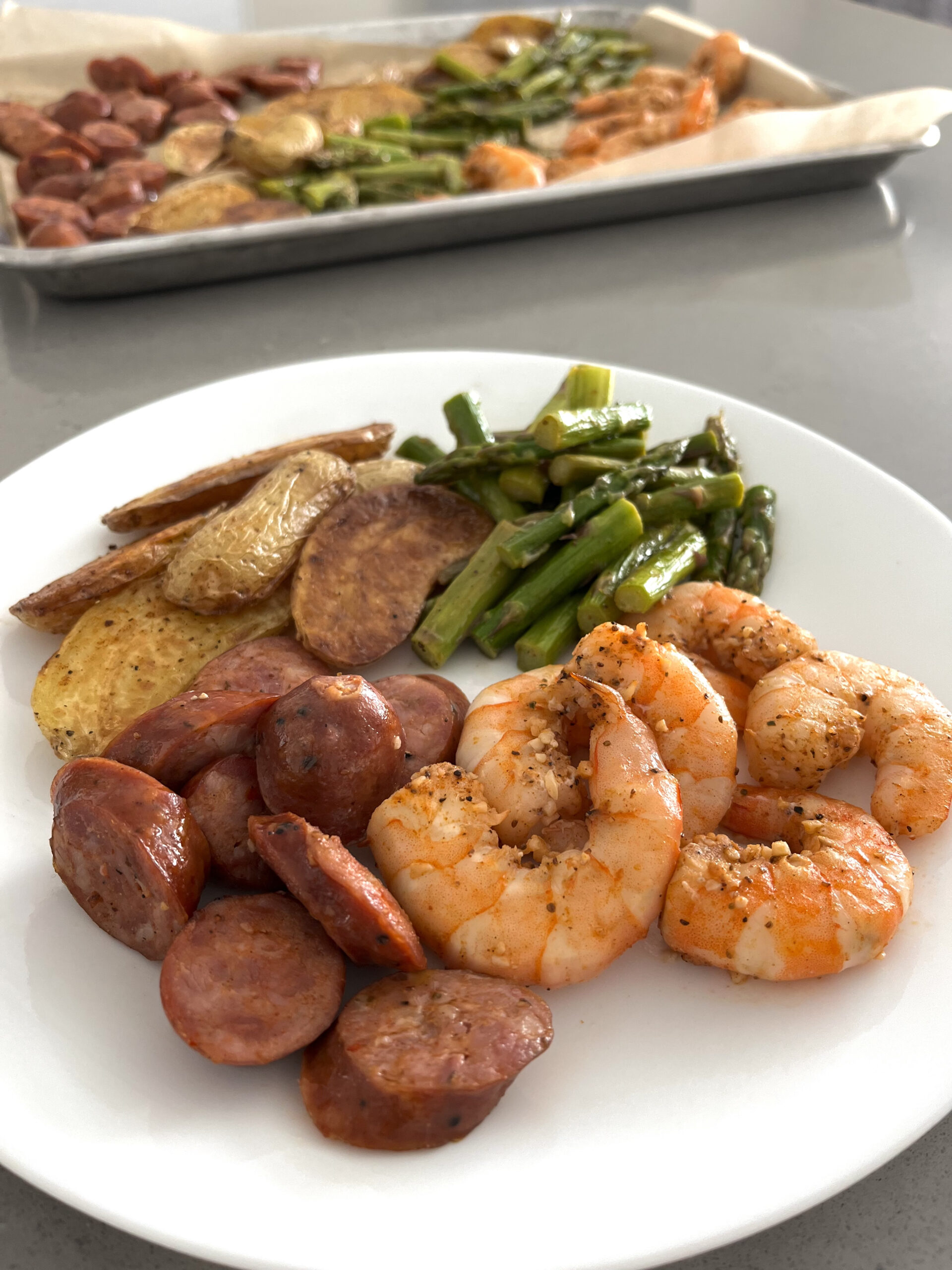 https://sarahkoszyk.com/wp-content/uploads/2022/12/Sheet-Pan-Cajun-Shrimp-Sausage-Asparagus-Potato-Plate-Side-View-scaled.jpg